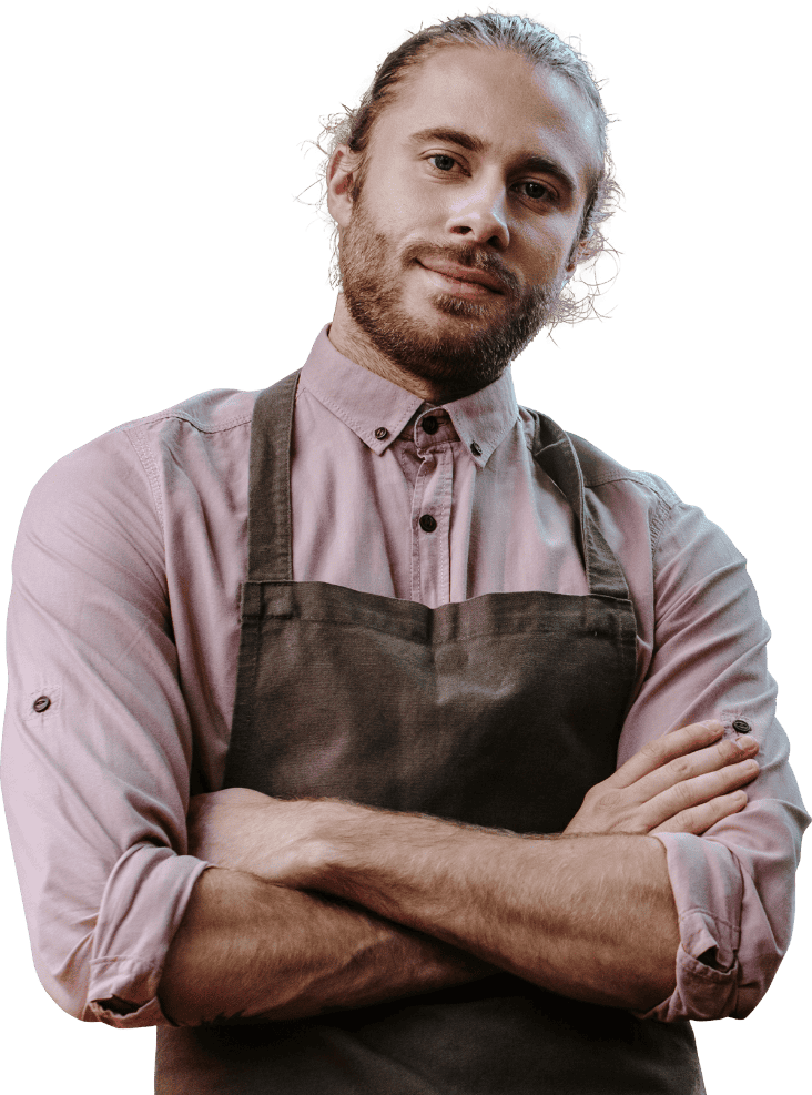Professional barber with folded arms wearing apron, ready to provide excellent service